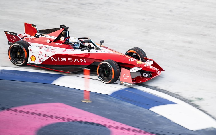 A photo of Nissan race car on track.